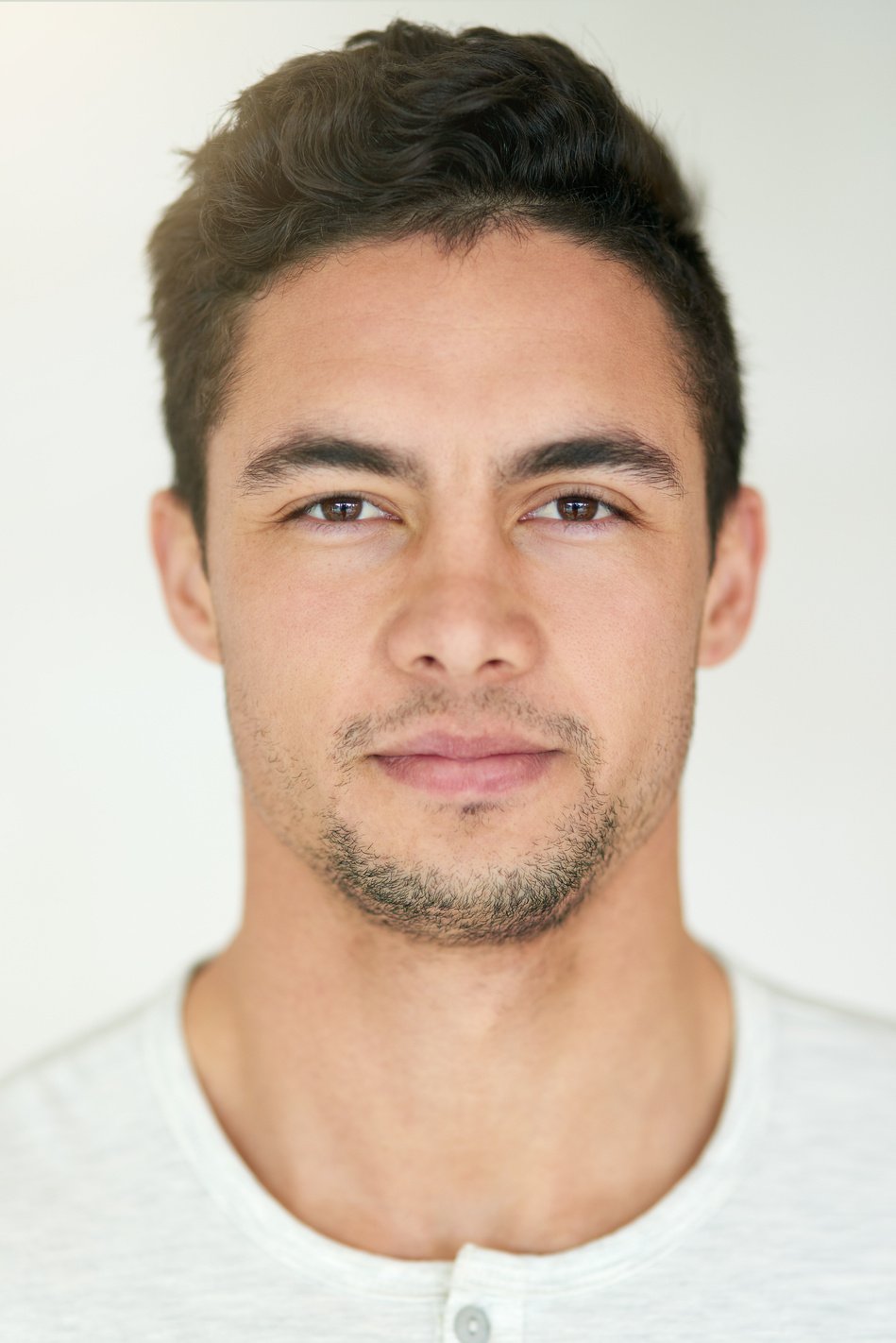 Portrait, Face and Headshot of Man in Studio, Isolated White Background and Posing with Casual Attitude. Handsome Young Guy, Serious Male Person and Pose for ID Photo, Passport Picture and Confidence