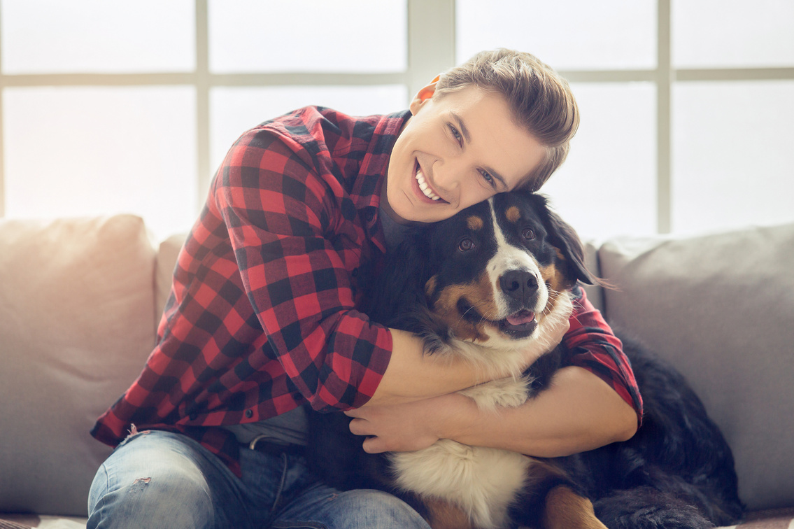 Young person with dog at home leisure