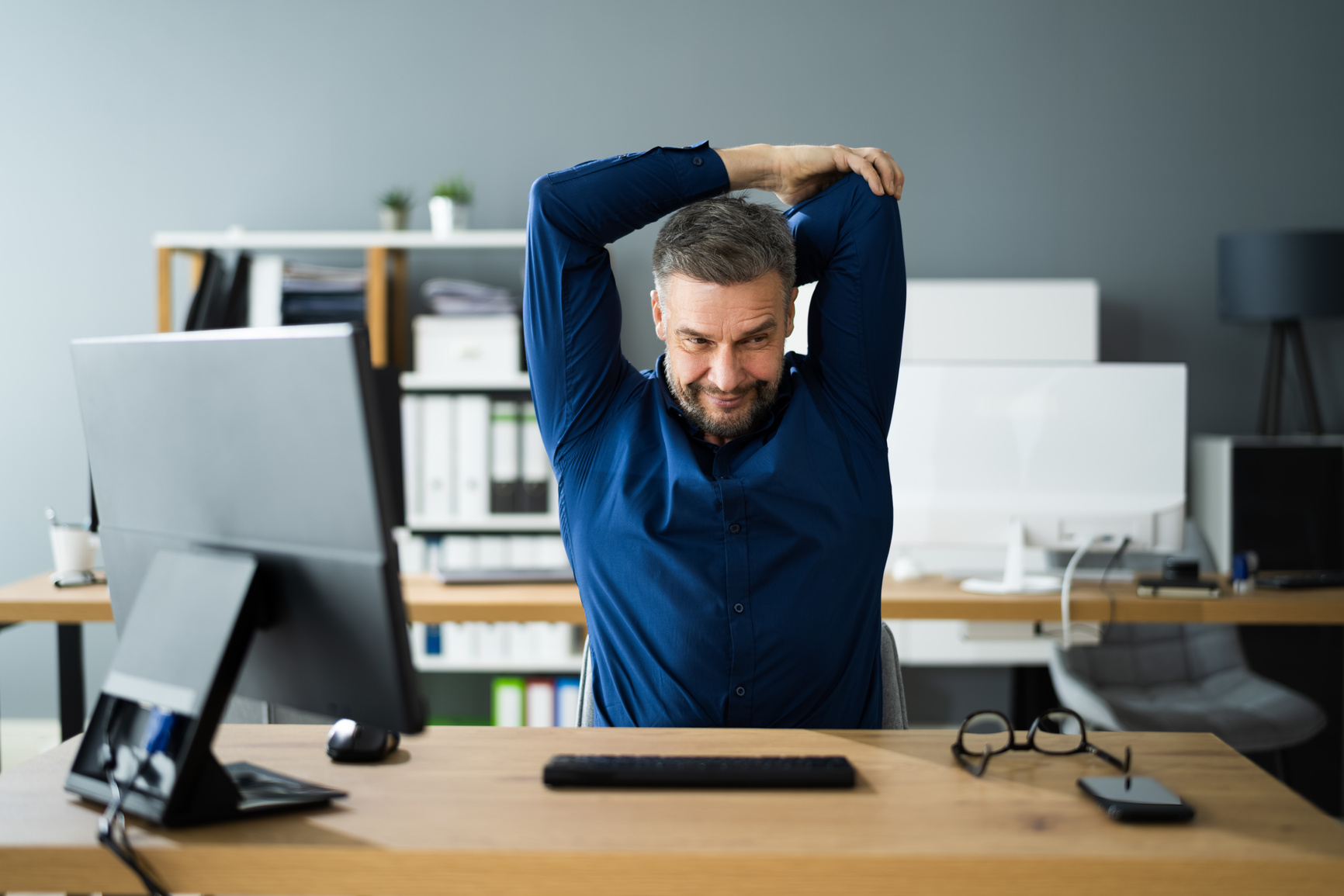 Stretch Exercise At Office Desk At Work