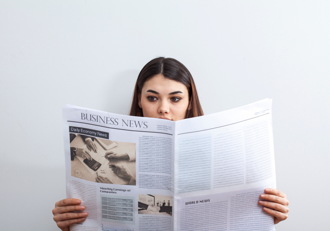 Woman Reading a Business Newspaper 