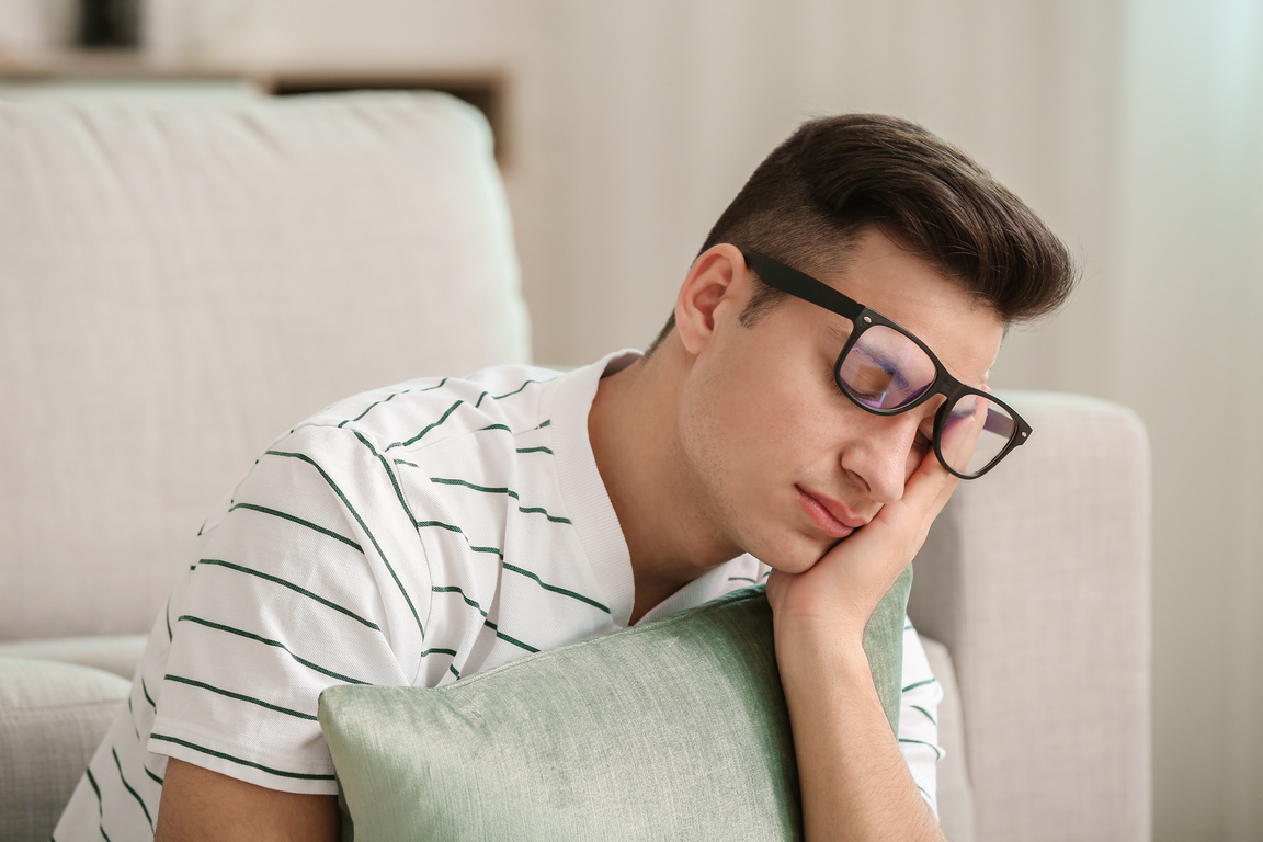 Man Suffering from Sleep Deprivation at Home