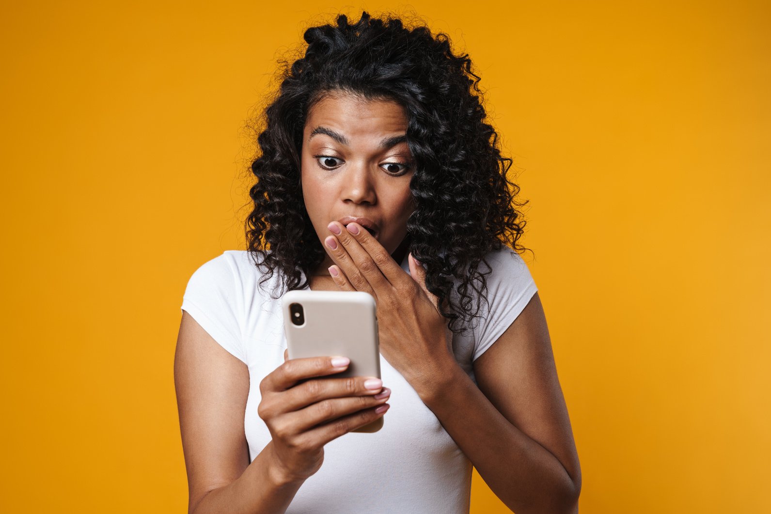 Image of Shocked African American Girl Using Mobile Phone