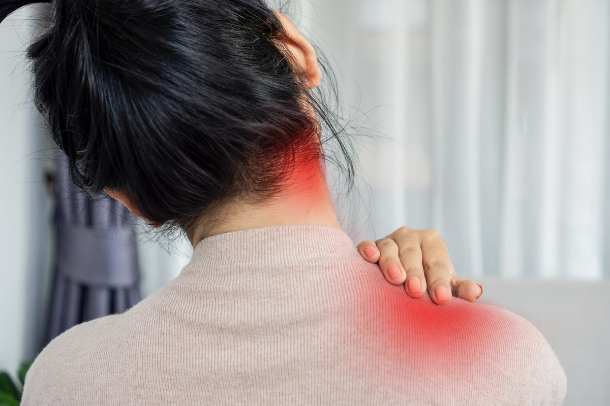 woman suffering from pain in a muscle behind the ear and down the neck and shoulder, sternocleidomastoid pain concept