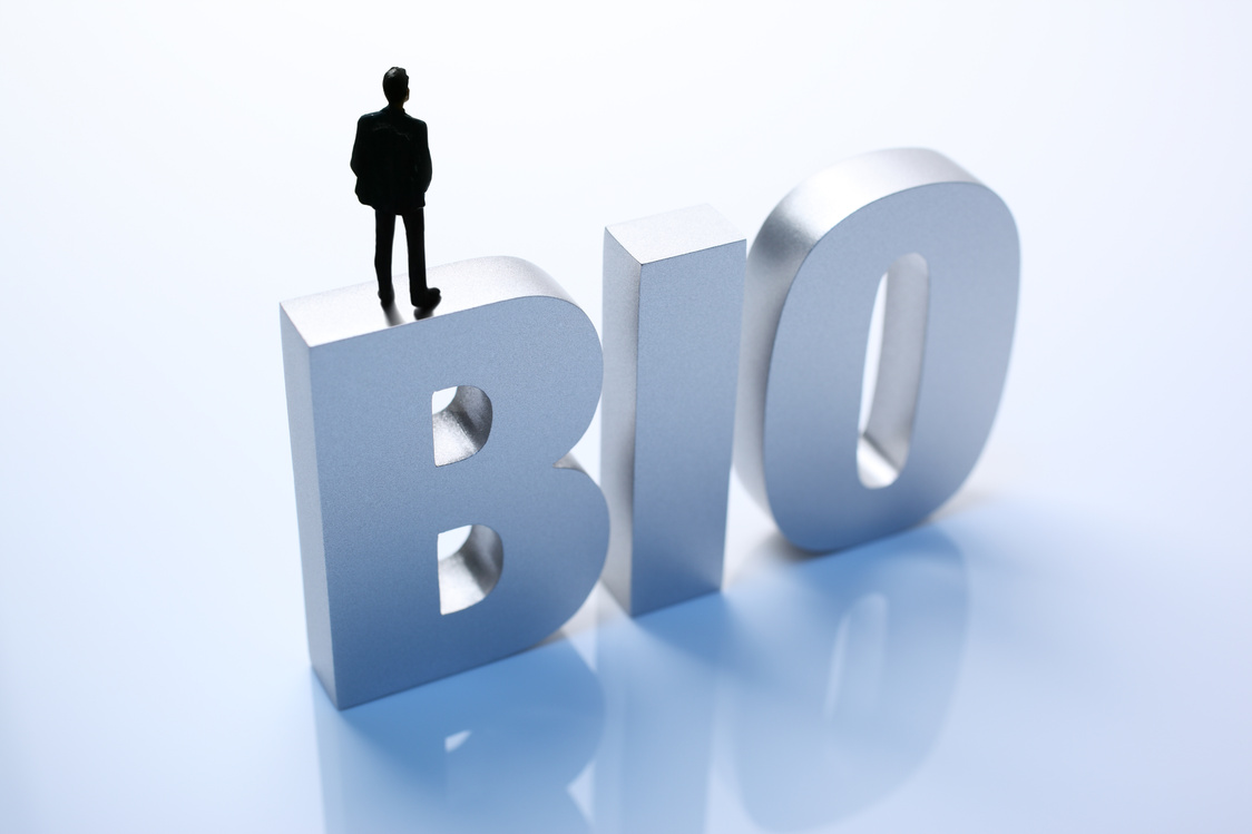 Figurine Businessman Standing on Big Letters BIO