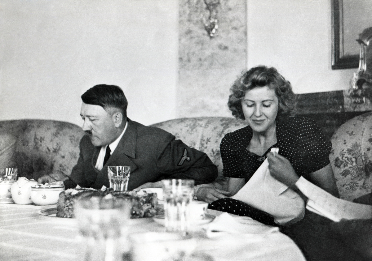 Hitler and Ava Braun at dining table at Berchtesgaden, ca. 1937-1943. Braun was the hostess at informal gatherings, but hidden away when high officials visited the Bavarian retreat. (BSLOC_2015_13_60)