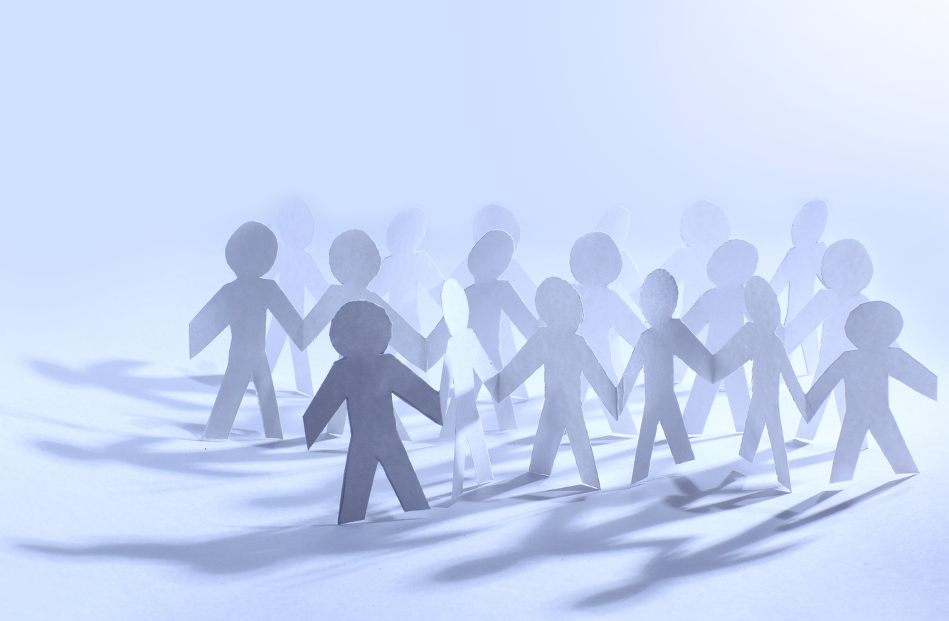 Team of paper doll people holding hands
