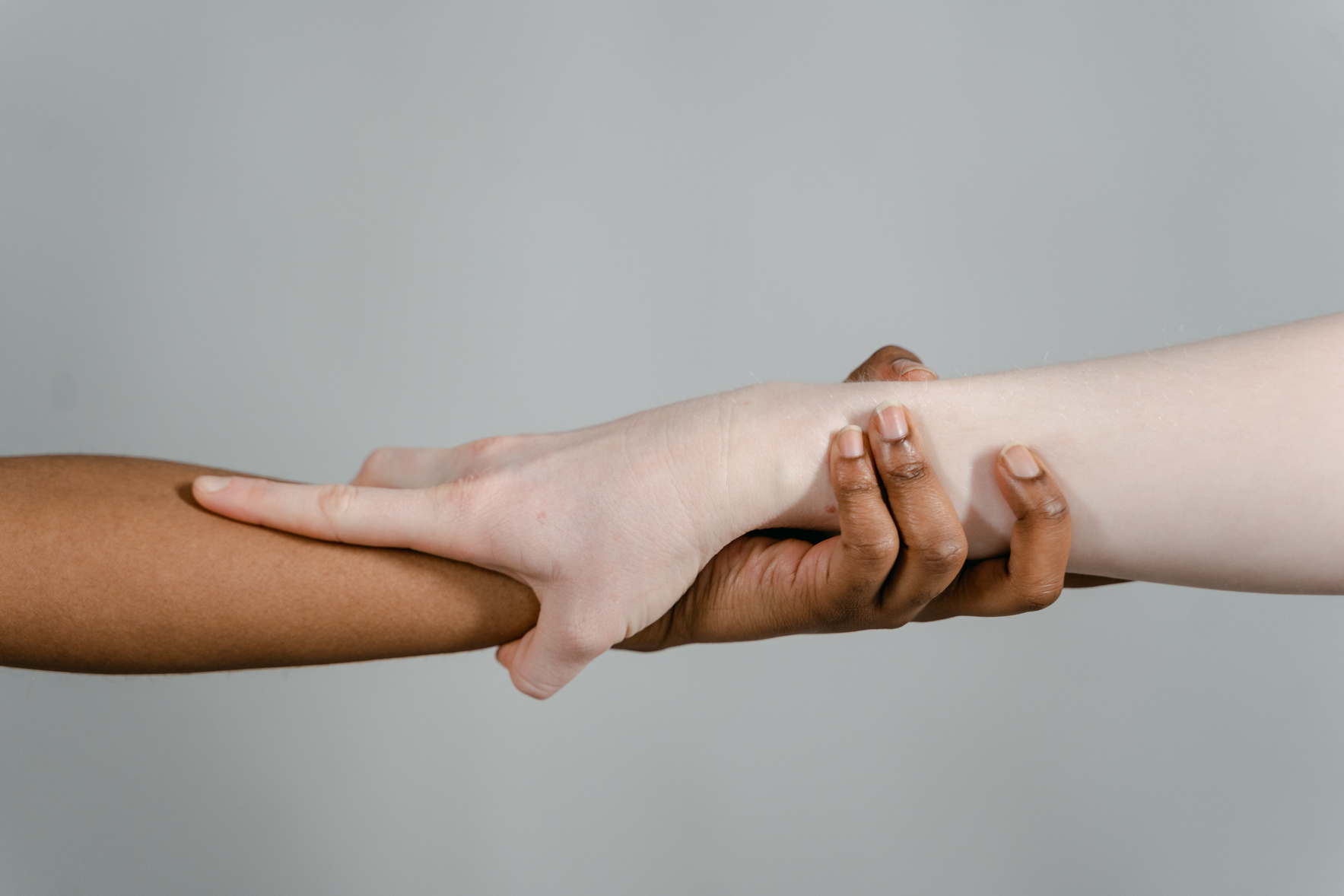 Close-Up Shot of a Tan and White Holding Hands